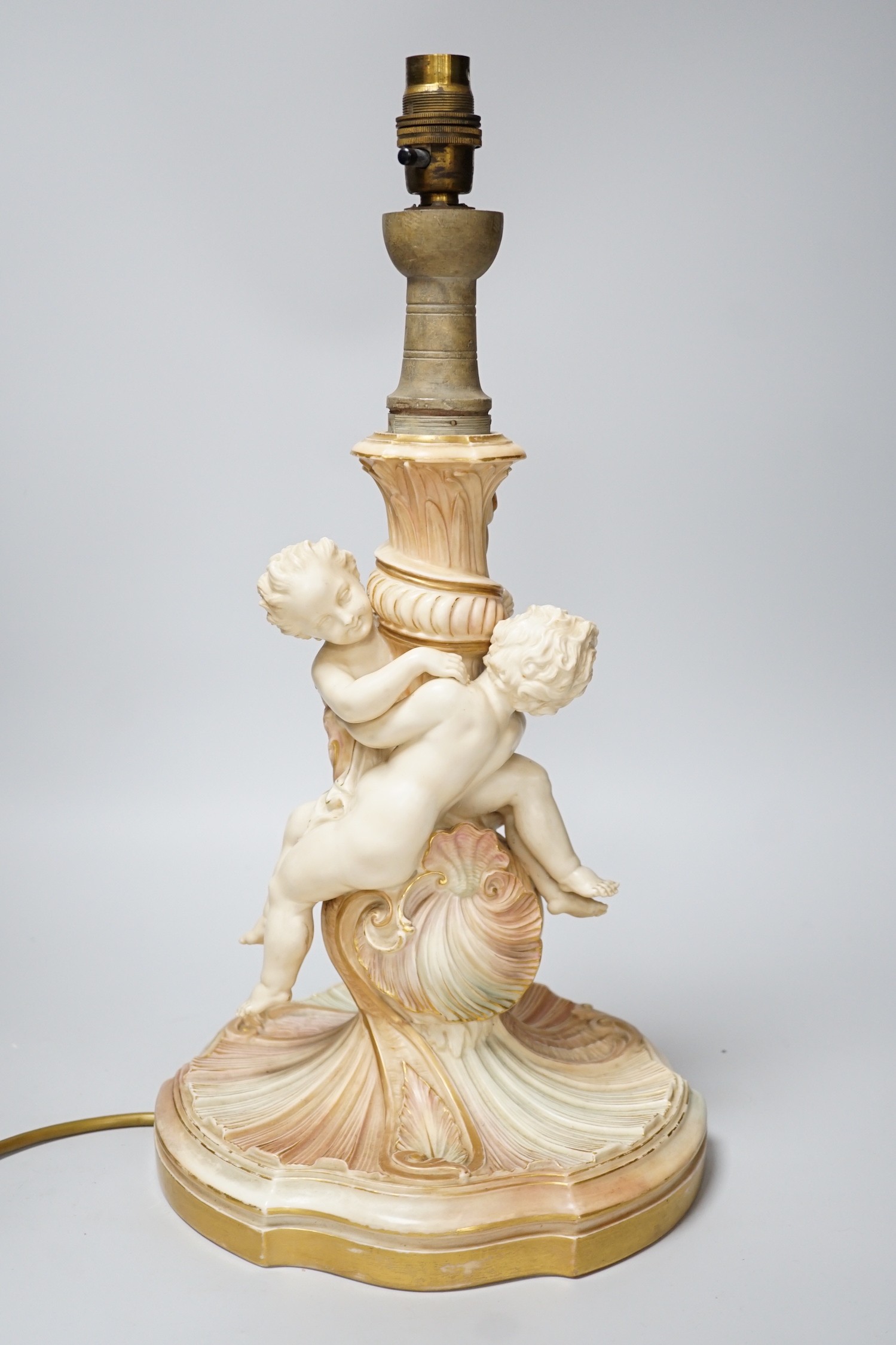 A large Royal Worcester blush ivory cherub lamp base, 40cm not including light fitting